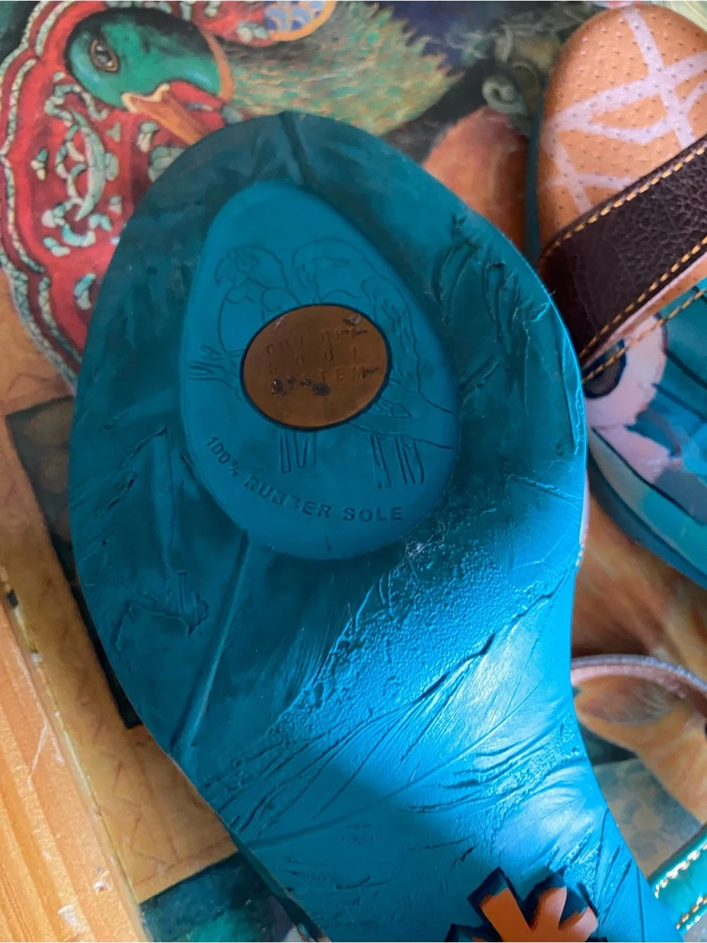 The Art Company, featuring a turquoise and multi-colored abstract pattern